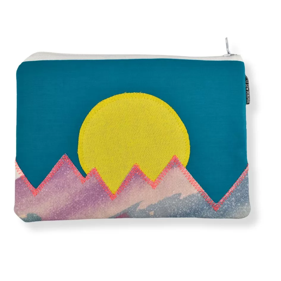 A small teal print fabric zipper pouch with a yellow sun and neon pink mountain applique.