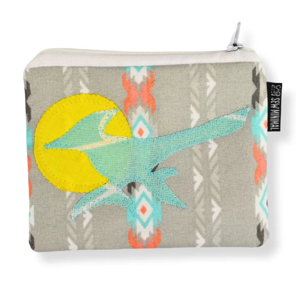 A small, gray southwest print coin pouch with a turquoise roadrunner and yellow sun applique.